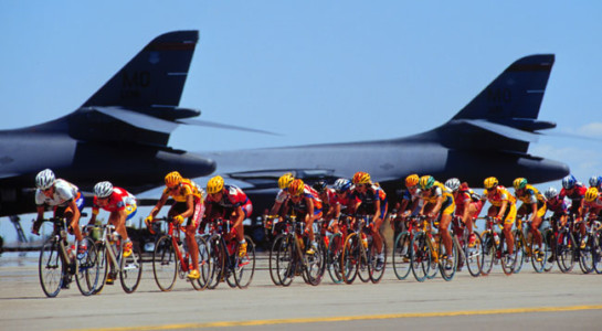 The peloton rides along the runway in front of a group of B-2 bombers during the 2000 race.